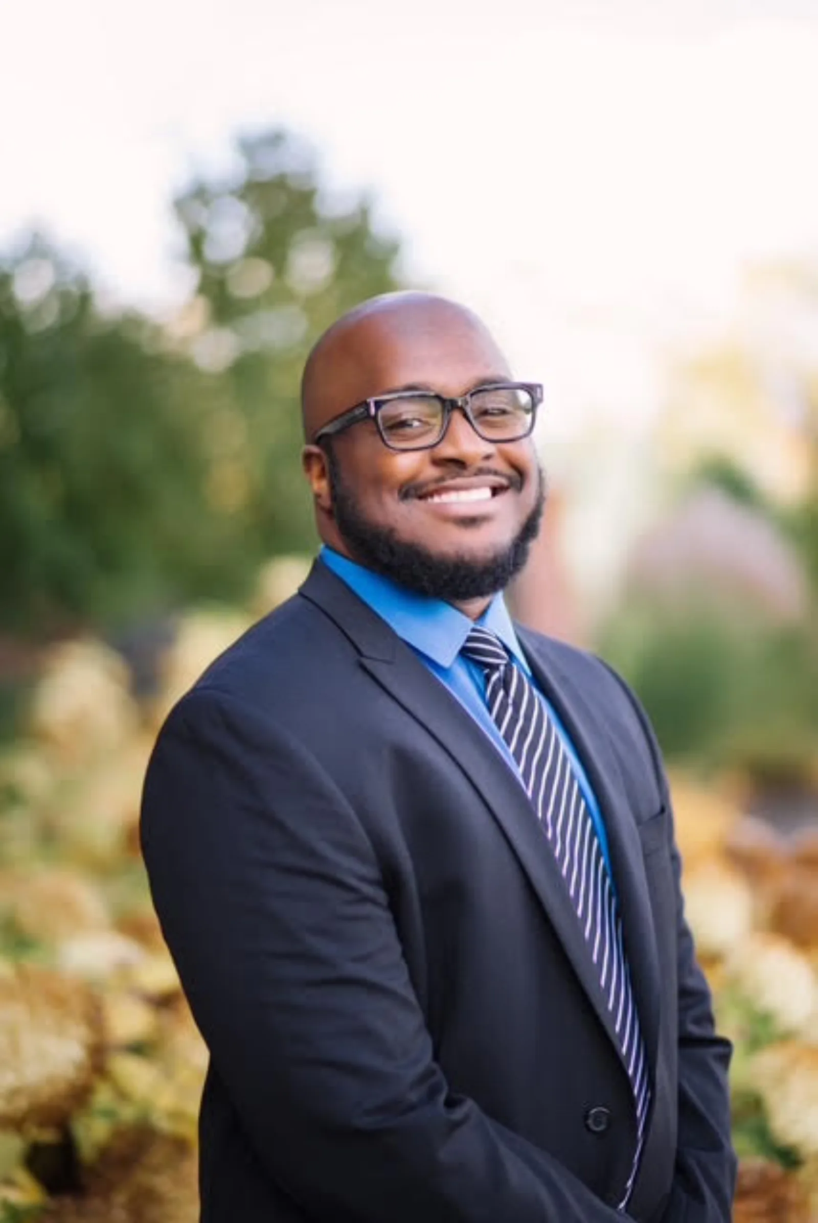 Dr. Alton Johnson, DPM, formal portrait in an autumn garden